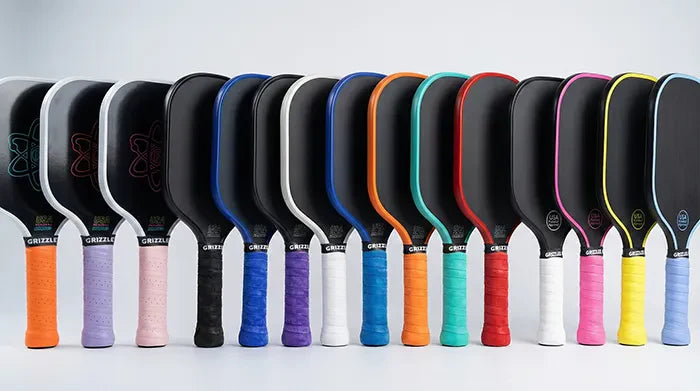 15 pickleball paddles with the handles all wrapped with the Grizzlee Gripz - Premium Pickleball paddle Overgrips 