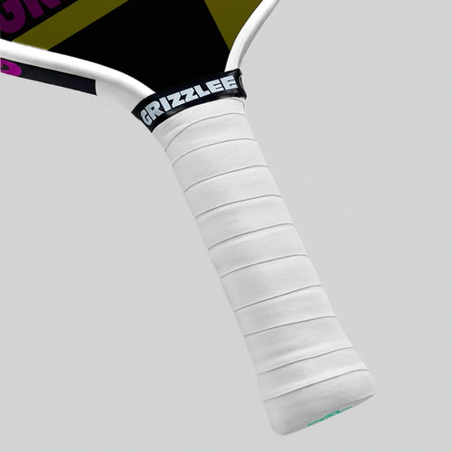 Close-up of a pickleball paddle handle with white grip and black 'Grizzlee' branding on a gray background