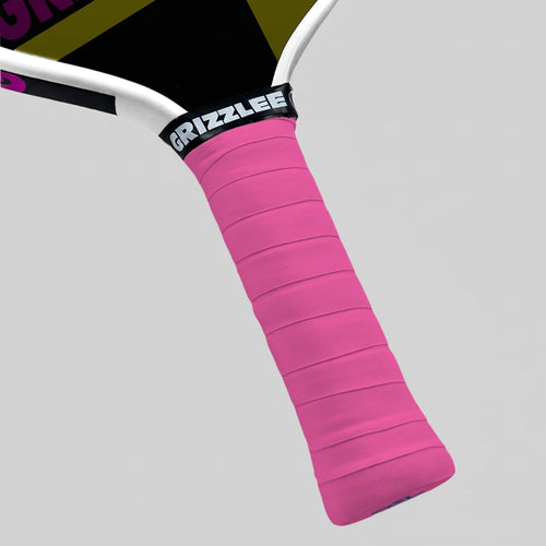 Pink pickleball paddle grip with 'Grizzlee' branding on a gray background