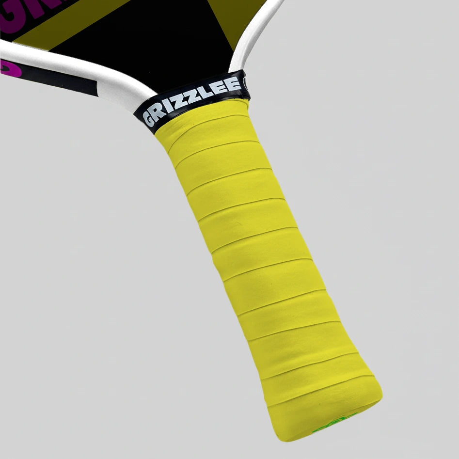 Bright yellow pickleball paddle overgrip and 'Grizzlee Gripz' branding on a gray background